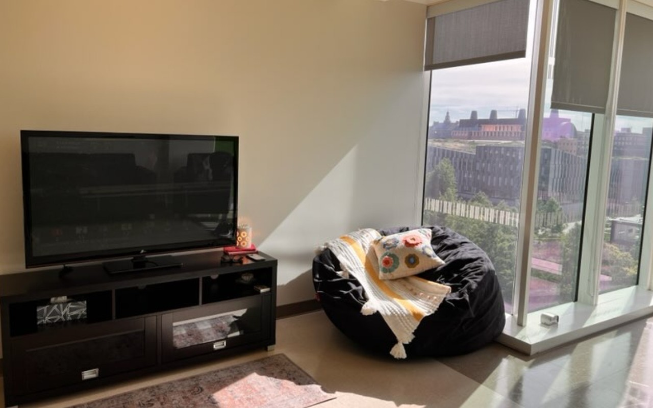 Marian Spencer Dorm room with TV and bean bag next to window wall