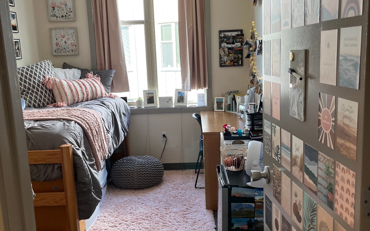 Dorm room decorated with curtains and pictures